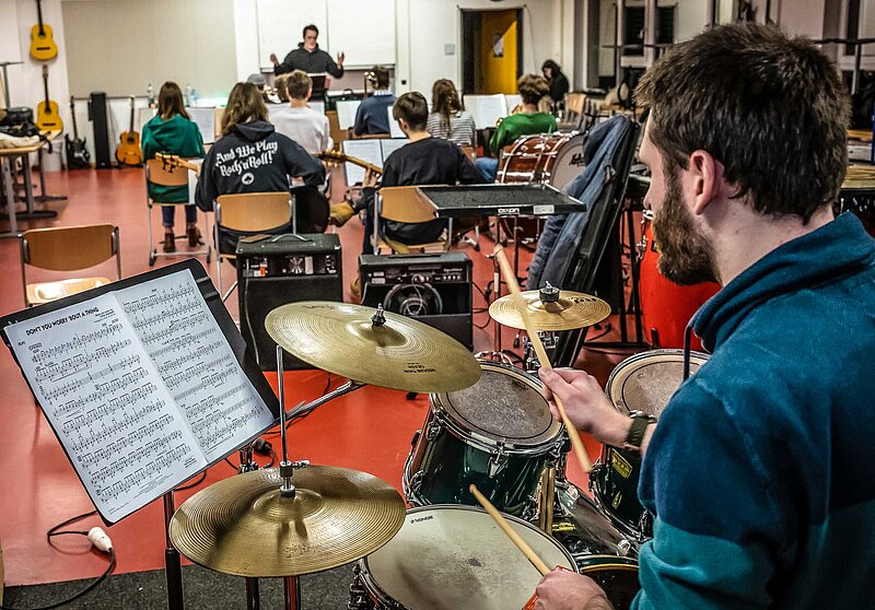 Bigbandprobe, Blick über die Schulter des Drummers ins Orchester bis zum Bandleader